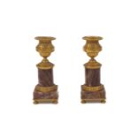 A pair of gilt brass and marble candlesticks, 20th century, the brass classical urns on