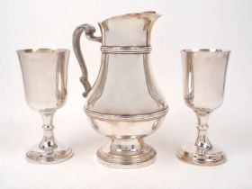 A large silver plated water jug, by Christofle, post 1983, the reeded baluster body with gilded