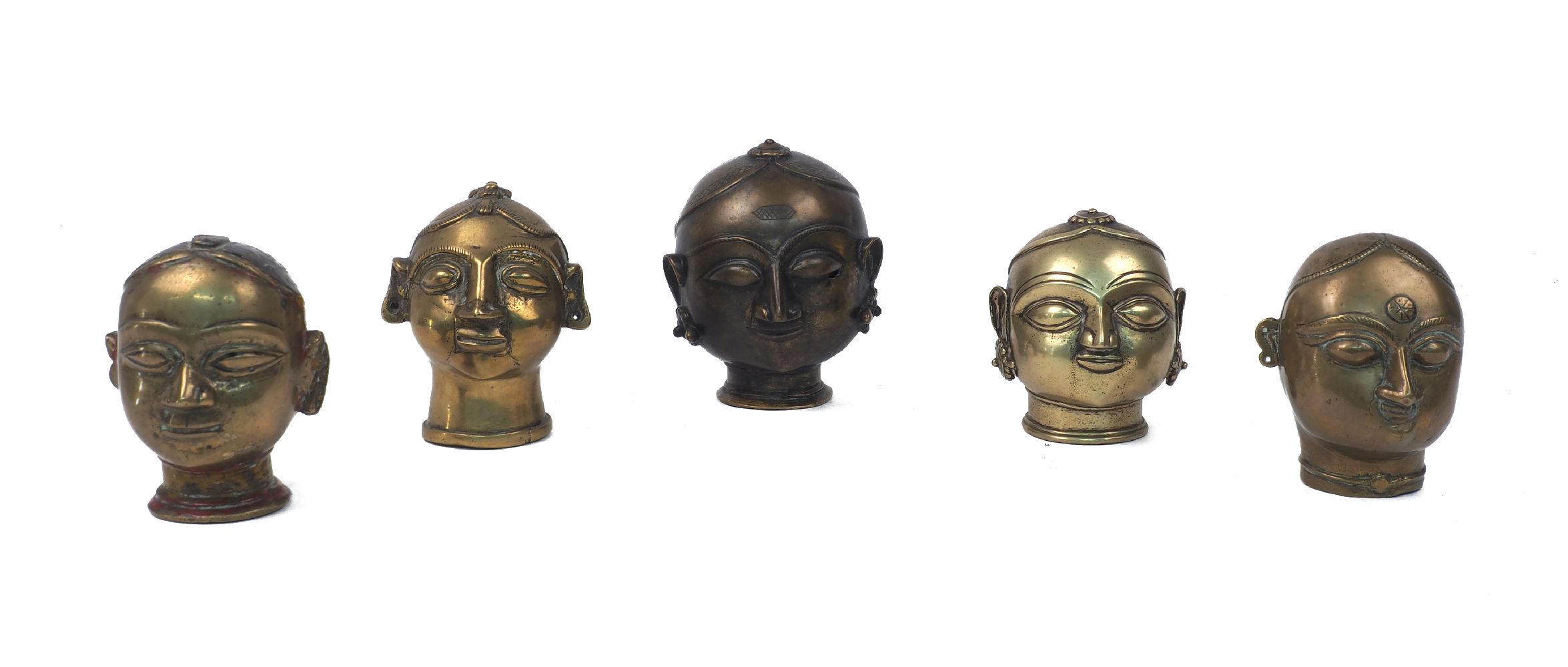 A group of Indian brass heads, 19th century or earlier, Hindu, depicting Gauri, one with remnants of