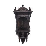 An Indian carved hardwood hanging corner niche, early 20th century, with domed top, carved with