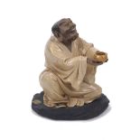 Liu Guibing, Tók Put Ló Hon, a glazed pottery figure of a seated beggar, bears label for Hong Kong