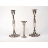A pair of silver candlesticks, London, 1963, A. Taite & Sons, the panelled stems to scalloped oval