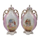 A pair of German ovoid twin handled vases, 20th century, of pink ground decorated in a Dresden style