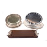A quantity of silver plated trays and serving plates, including a rectangular wooden tray with