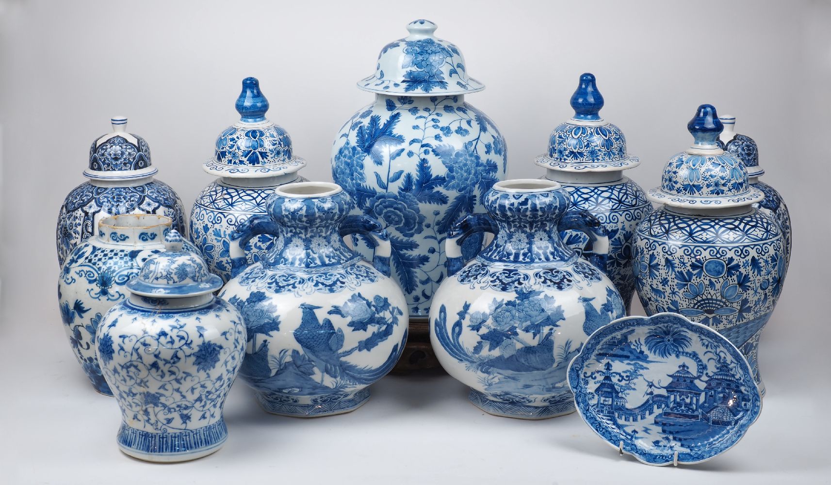 A group of blue and white ceramics, 20th century, comprising: a pair of Delft vases and covers, 43cm