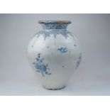 A large continental glazed terracotta vase, 19th century, decorated in blue and white with birds