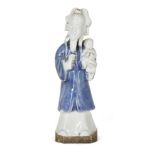 A Chinese porcelain figure, 18th century, modelled as a standing figure covered in a qingbai glaze