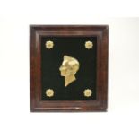 A Victorian gilt-bronze relief portrait of Prince Albert, mounted on a green velvet board with
