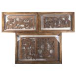 Three framed carved oak tracery panel fragments, 17th-19th century, with scrolling foliate motifs,