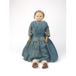 A wax over composition doll, with brown pupil-less eyes on cloth body with leather lower arms,