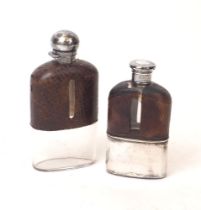 Two Victorian silver and leather mounted glass hip flasks, the larger example London, 1889, the
