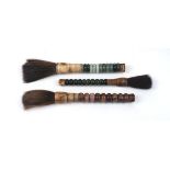 Three Chinese hardstone and bone calligraphy brushes, 20th century, 31.5 - 36cm long (3)Please refer