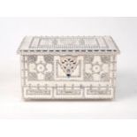 A jewellery box designed as a casket, elaborately decorated with beaded patterns, the lid opening to