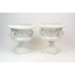 A pair of Continental white glazed pottery twin handled campana urns, 20th century, the bodies