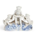 A Chinese Dehua porcelain 'monkeys' figure group, early 19th century, depicting three monkeys sat