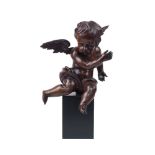 A carved and stained wood cherub, 19th century, possibly once atop a mirror or frame, modelled
