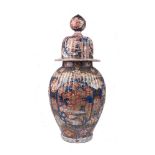 A large Japanese Imari jar and cover, late 19th century, of baluster form, decorated with panels