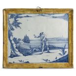 A Delft blue and white plaque, c.1760, decorated with a landscape scene featuring a dog and its