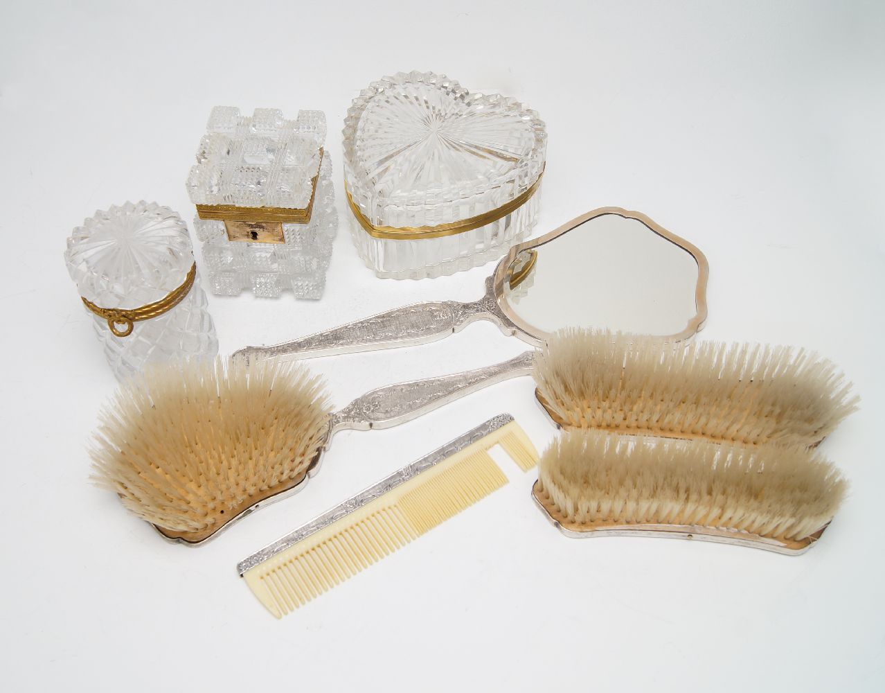 A ruby and red gem-set dressing table set, stamped 800 for silver, comprising a hand mirror and four