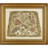 A framed English woolwork seat cover, 18th century, with fruit, flowers and a wavy green border,