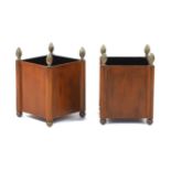A pair of miniature metal faux wood cachepots, of square form with pineapple finials, on ball