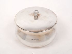 A lidded circular silver dish, Birmingham, c.1911, John Grinsell & Sons, of round waisted form with