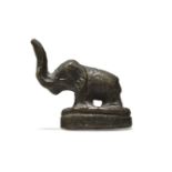 A Chinese bronze small elephant, Ming dynasty, 17th century, cast standing four square on an oval