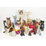 A collection of varying vessels modelled cats, to include; spill vases, jugs, vases, a teapot and