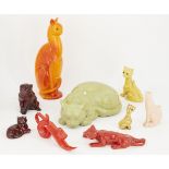 A collection of pottery cats glazed in reds, orange, yellow and cream, some with indistinct marks to