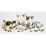 A quantity of pottery Siamese cats, to include seven Seneshall cats, with painted signature and