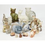 A collection of pottery cats, each with ash glaze or similar, to include; a seated cat with hand