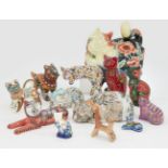 A collection of pottery cats, to include three cats, after Moorcroft, with raised outline floral