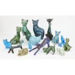 A collection of pottery cats glazed in greens and blues, to include two 19th century style Torquay