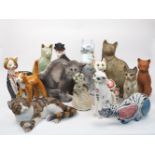A collection of large pottery cats, to include; a green glazed cat, hand painted with flowers,