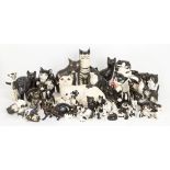 A collection of black and white pottery cats, including; examples of factory made, studio pottery