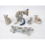 A French faience cat by Fourmaintraux, Desvres, c.1910, modelled in a jaunty pose and decorated with