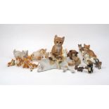 A quantity of pottery cats of a stylistically realistic nature, to include; two Royal Worcester bone