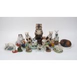 A collection of pottery cats, each raised on base, to include; two Victorian Staffordshire pen