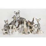 A collection of black and white striped ceramic cats, to include; examples of studio pottery and