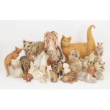 A collection of biscuit fired pottery cats, to include a large Abington pottery cat attributed to