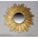 A gilt starburst wall mirror, second half 20th Century, the circular mirror plate set within rope