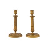 A pair of Charles X ormolu candlesticks, second quarter 19th century, of column form with urn