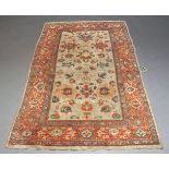 A Caucasian woollen rug with ivory field and red main border, 209cm long, 121cm wideSurface wear and