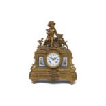 A French gilt-bronze mantle clock, mid 19th century, the case with Bacchic figure and goat above