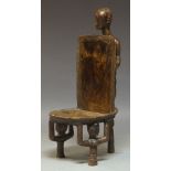 A Tanzanian figural carved chieftain's chair, 20th Century, the rounded rectangular backrest and