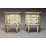 A pair of painted demi-lune bedside tables, early 20th century, with three drawers raised on