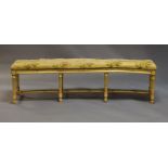 A French painted curved window seat, late 19th century, the over stuffed seat above floral painted