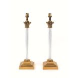 A pair of lucite and brass column table lamps, late 20th century, each with Corinthian capital and