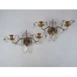 A pair of brass twin-light wall appliques, late 20th century, each hung with facetted glass drops,