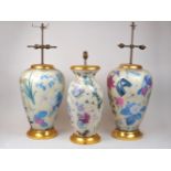 A pair of modern reverse-glass printed botanical lamp bases, decorated with blossoming flowers and